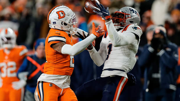 New England Patriots wide receiver DeVante Parker (1) makes a catch under pressure from Denver Broncos cornerback Pat Surtain II (2) in the third quarter at Empower Field at Mile High.